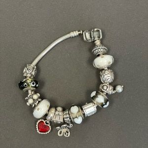 Pandora bracelet. black, white, and red murano, silver, and stoned charms